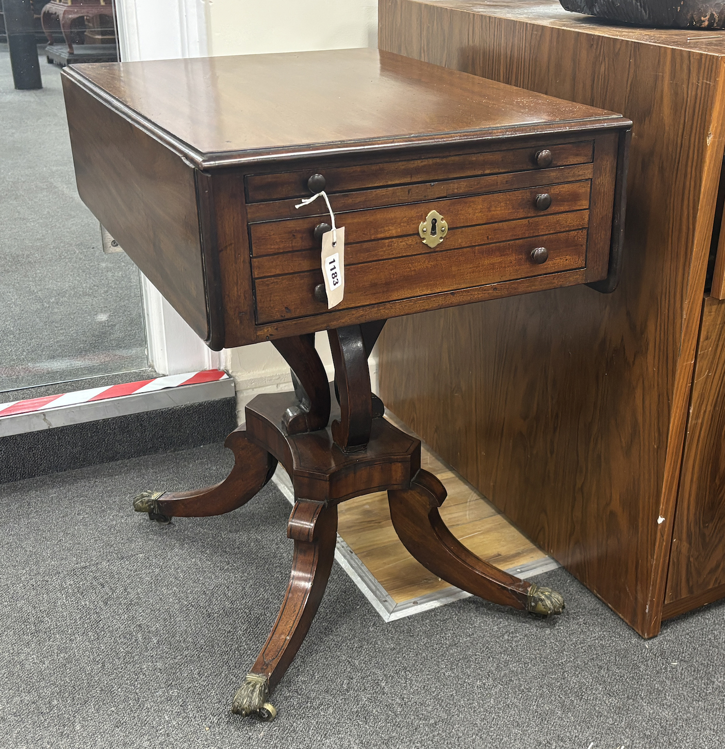 A Regency ebony strung mahogany drop flap two drawer work table, width 45cm, depth 64cm, height 67cm.